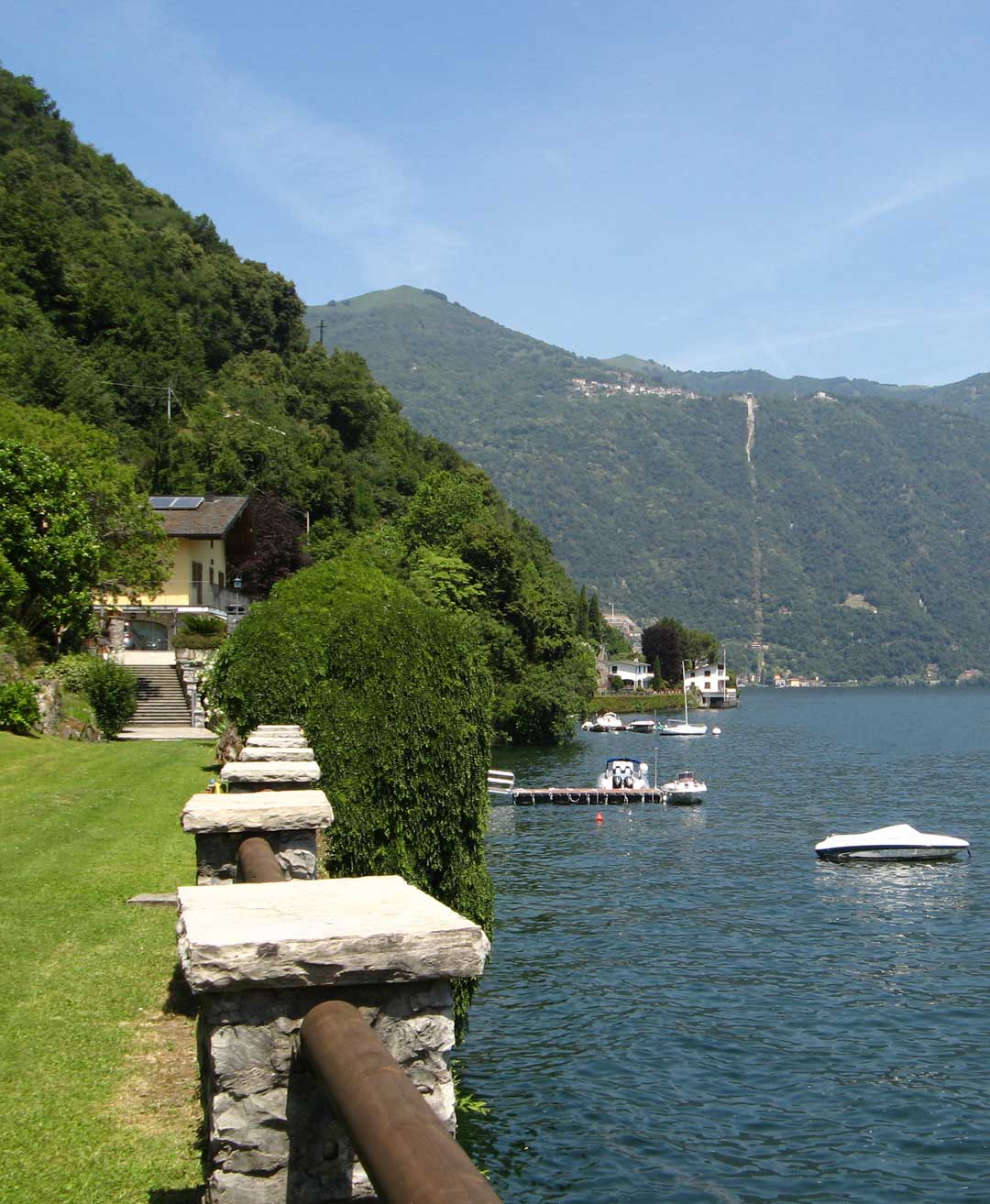 View of the private Telos Boats dock from the lakeside garden reserved for guests before and after their boating experience.