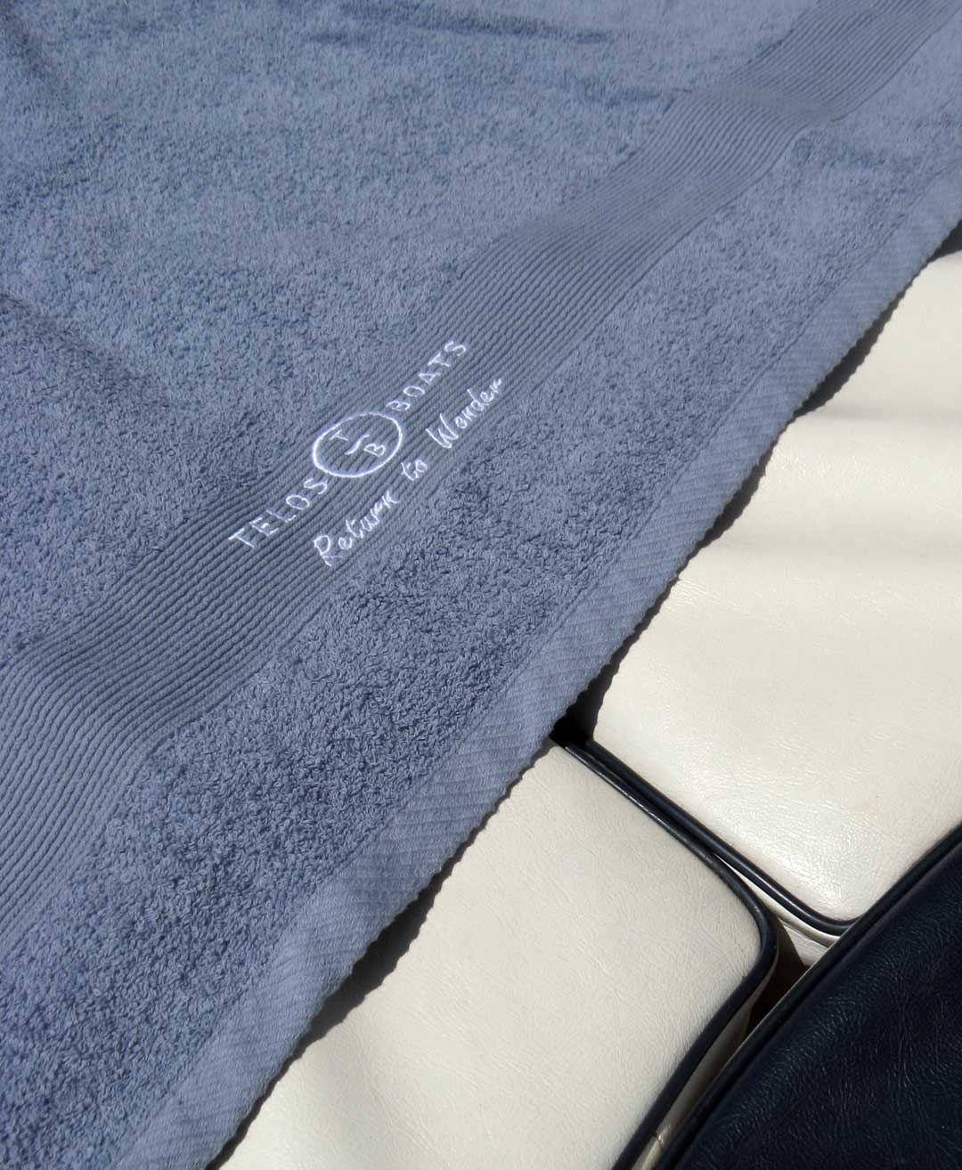 Personalized Telos Boats towel provided for guests during their Lake Como boat rental experience.