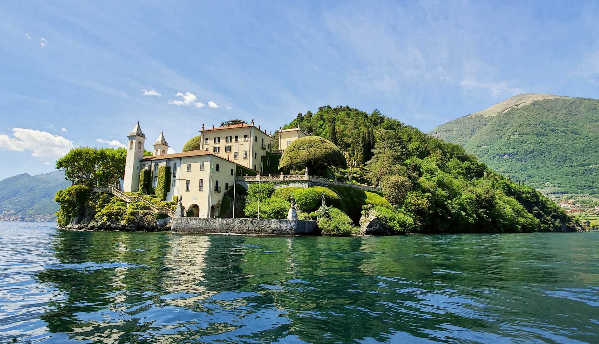 View of Villa del Balbianello from a self-drive boat on Lake Como.